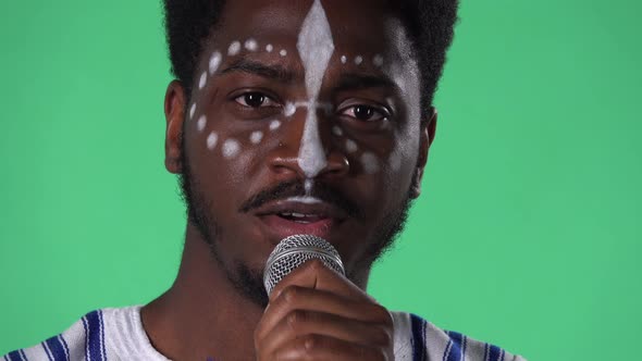 Portrait of Young African American Man Singing Song Into the Microphone