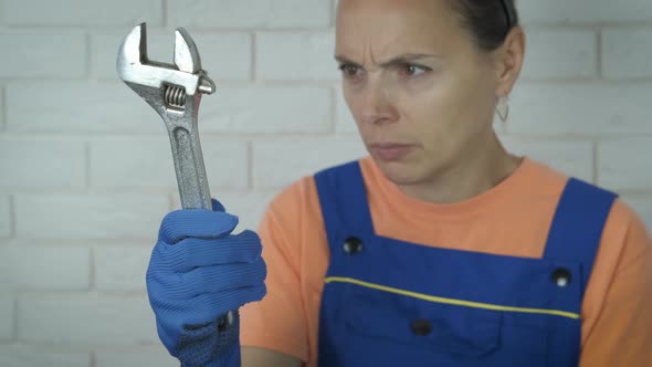Surprised Woman with Monkey Wrench