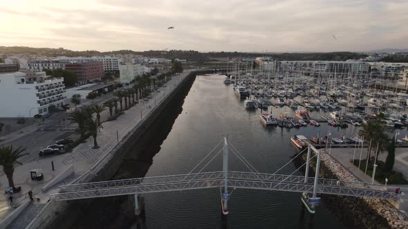 Aerial shot over a boat dock and marina with yachts on the coast of Portugal