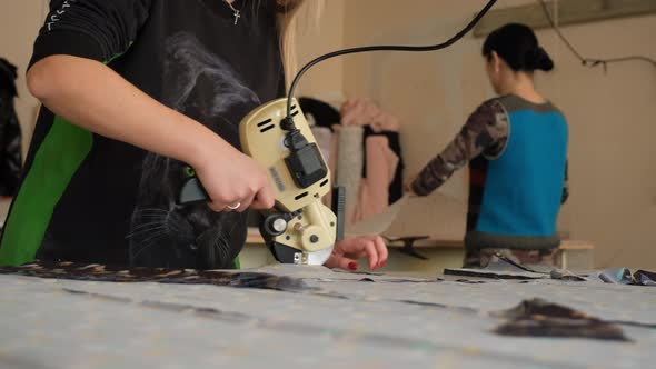 Female Workers Cutting Fabrics for Clothes