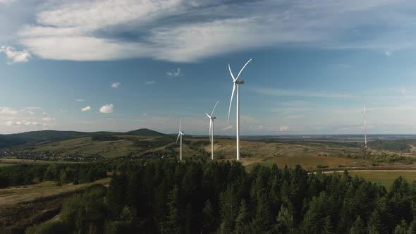 Camera Flight Over Landscape with Power Plant. Aerial View To Wind Turbine. Sustainable Electricity