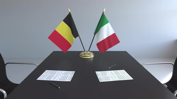 Flags of Belgium and Italy on the Table