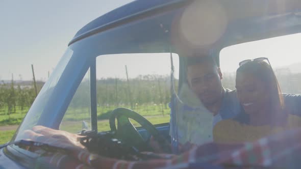 Young couple on a road trip in their pick-up truck