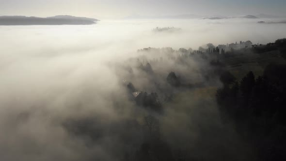 Aerial view of morning fog over forest in Umbria, Italy