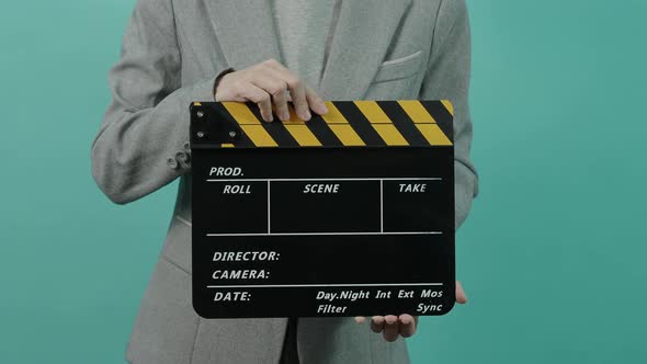 Movie slate or clapperboard hitting. Business woman holding empty film slate and clapping it.
