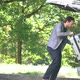 Slow motion shot of man putting luggage in back of car - VideoHive Item for Sale