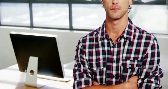 Portrait of executive standing with his arms crossed