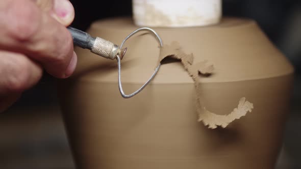 Potter Use Cutter with Which He Removes Thin Shavings From Raw Clay Vase Closeup