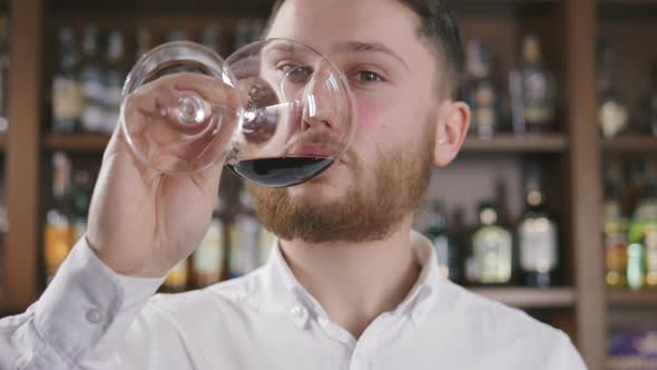 Sommelier Tating the Wine