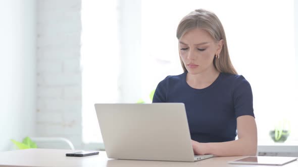 Woman Celebrating Online Success in Office