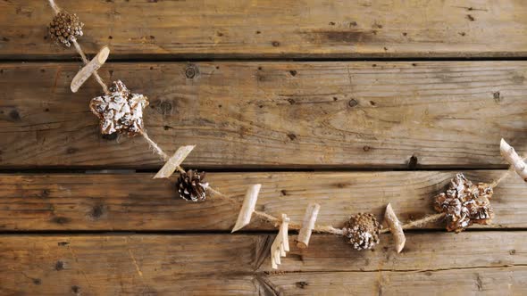 Christmas decoration on a thread against wooden background