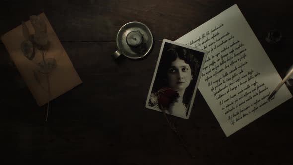 Handwritten letter with quill and extinguished candle