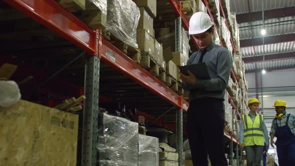 Male Supervisor Checking Goods in Warehouse