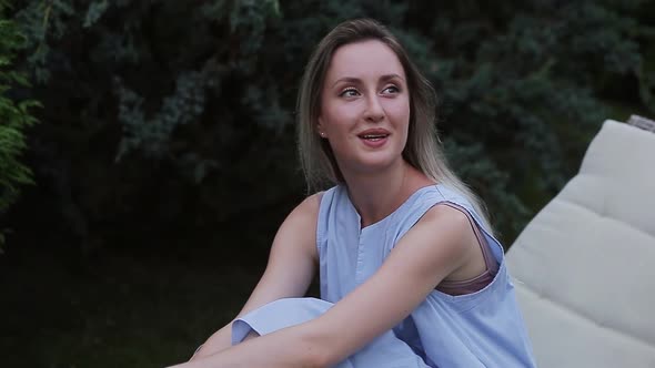 Beautiful Girl Sitting in the Garden Smiling