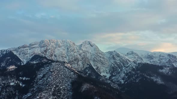 Panorama Of Snowy Tatra Mountain Range With Forest During Winter In Europe. - aerial