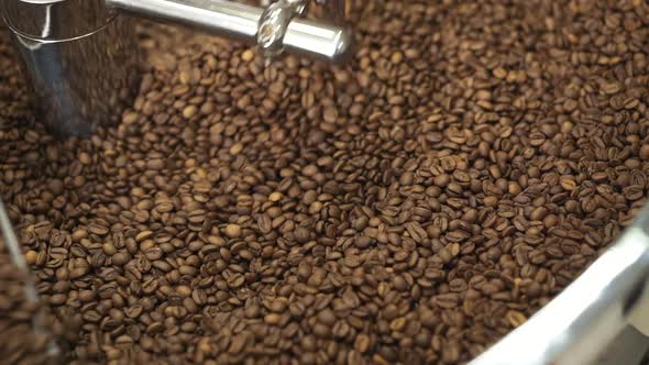 Close View of Mixing Roasted Coffee Beans in Professional Equipment