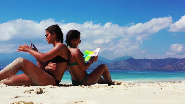 Ladies together tan on relaxing island beach adventure by transparent lagoon with white sand backgro