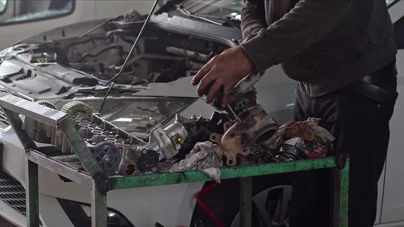 Mechanic Checking Car's Defective Turbocharger At Car Repair Shop 3