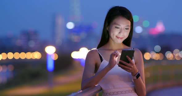 Asian woman use of cellphone at night