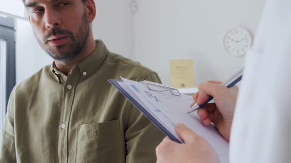 Man Patient Showing Sore Arm to Doctor at Hospital