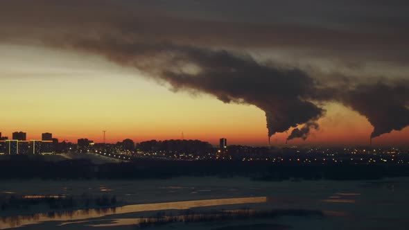 Lights of Evening City Glow Against the Backdrop of Smog Polluting Atmosphere.