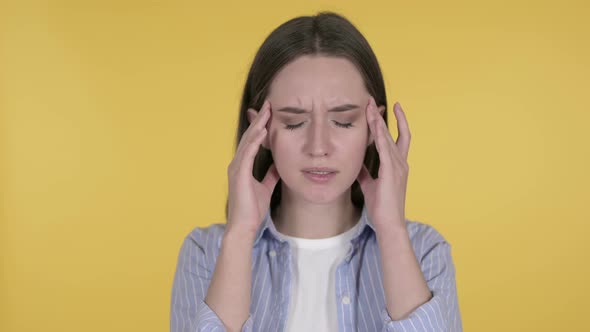 Young Woman with Headache on Yellow Background