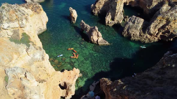 Drone shot of kayaks and boats passing around. Exploring caves and tunnels. Travel and adventure