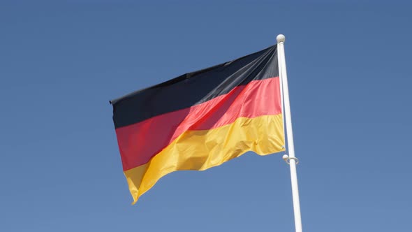 Flag of Germany waving in front of blue sky 4K 2160p 30fps UHD footage - Recognizable German nationa