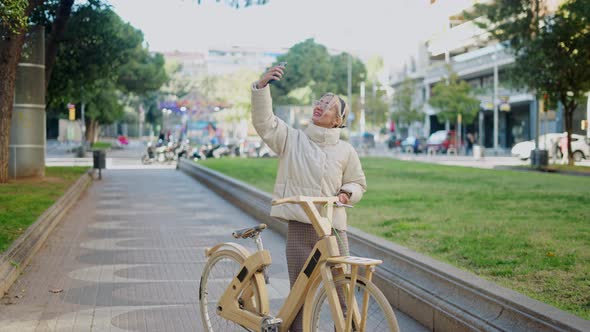 Stylish Woman Taking Selfie with Bicycle