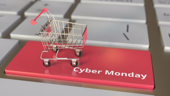 Cyber Monday Text on Keyboard and Boxes in Small Shopping Cart