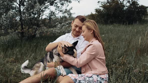 A young and lively couple spend their moments with their favorite dog