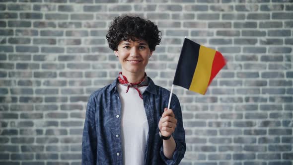 Slow Motion Portrait of Beautiful Woman Holding German Official Flag Smiling