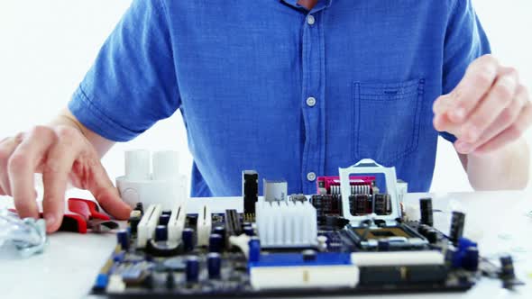 Computer engineer repairing computer motherboard