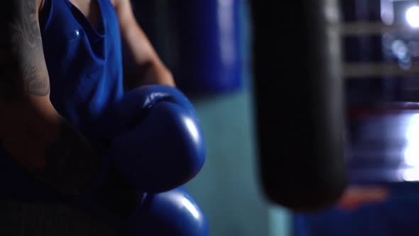 Closeup Hands of Unrecognizable Boxer Male Putting on Boxing Gloves Before Training Punching Bag in