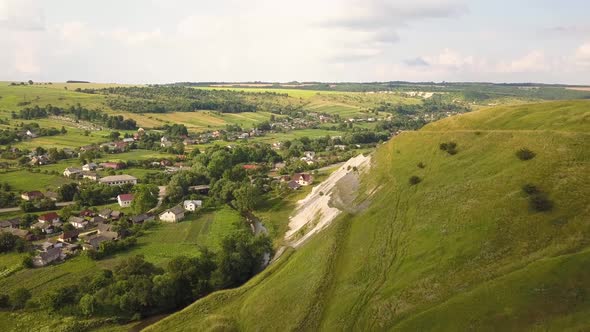 Aerial view of a small village between green summer hills in ukrainian Carpathian