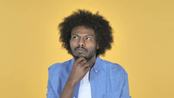 Thinking AfroAmerican Man with New Plan on Yellow Background