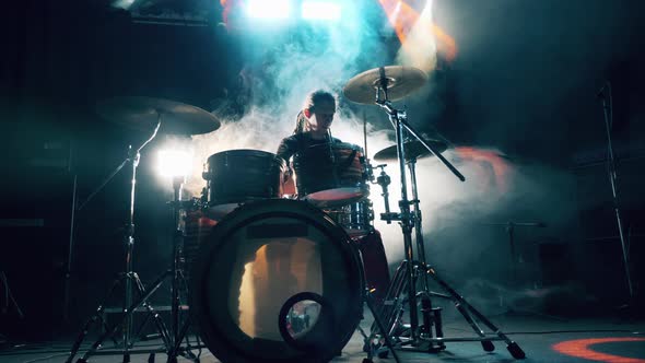 Rehearsal Studio with a Man Playing the Drum Set