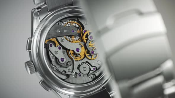 Closeup on the luxury watch with gears and mechanism visible through the glass.