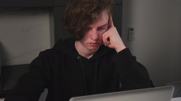 Portrait of Upset Tired Man Using Laptop at Home Office