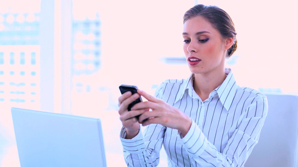 Attractive Businesswoman Using A Mobile Phone