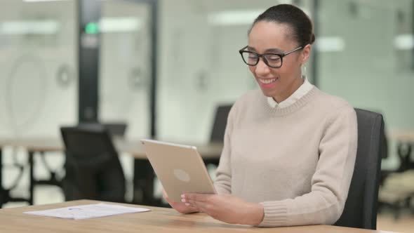 Creative African Woman Talking on Video Call on Tablet