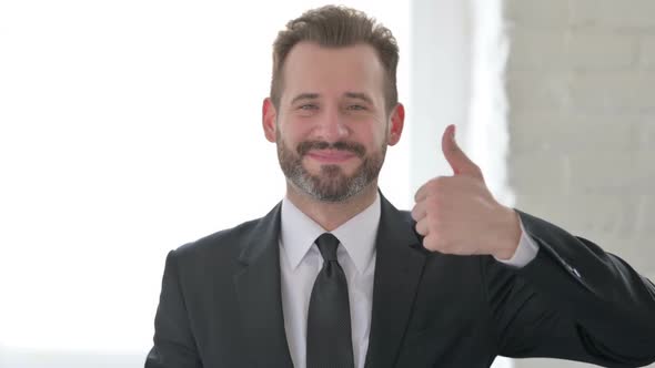 Positive Middle Aged Businessman Showing Thumbs Up