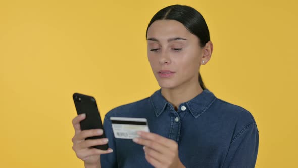 Online Shopping on Smartphone By Latin Woman, Yellow Background 