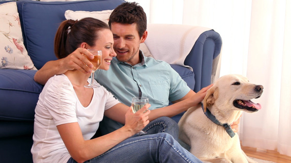 Happy Couple Sitting Floor Drinking Wine