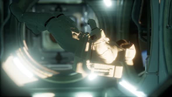 Astronaut Inside the Orbital Space Station alt