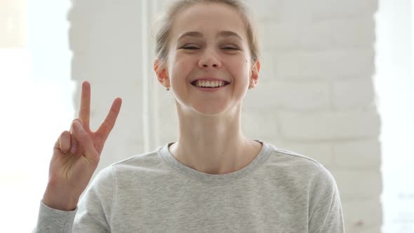 Victory Sign By Successful Young Woman