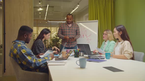 Businessman Motivating Team for Successful Work