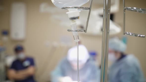 Dropper Holder in the Background of a Medical Operation