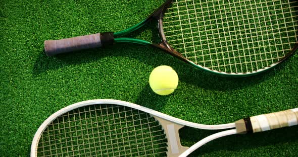 Tennis ball and rackets arranged on grass 4k