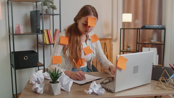 Exhausted Woman Freelancer with Pasted Stickers Using Laptop Having Concentration Problem in Office